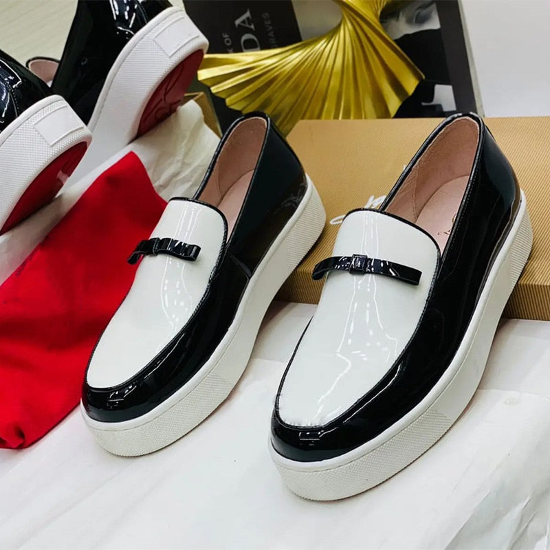 Patent leather slip-on loafers in black and white